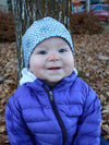 Baby girl wearing grey print winter hat